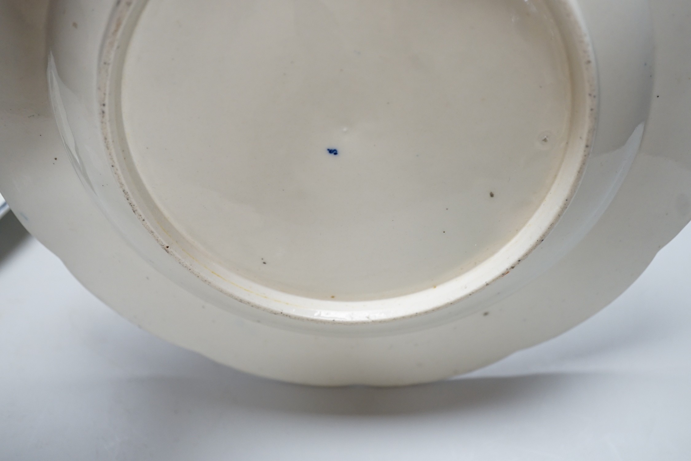 An 18th century Caughley plate printed with Gillyflower variation 5, 20.5cms diameter and two plates with the Carnation pattern, one with added polychrome decoration
